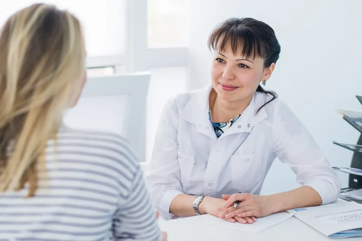 DNP Prepared Nurse Practitioner Consulting with Patient
