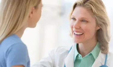 Family Nurse Practitioner with Post Master's Certificate Smiling at Young Patient