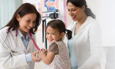 Nurse Practitioner Smiling Holding Laughing Infant